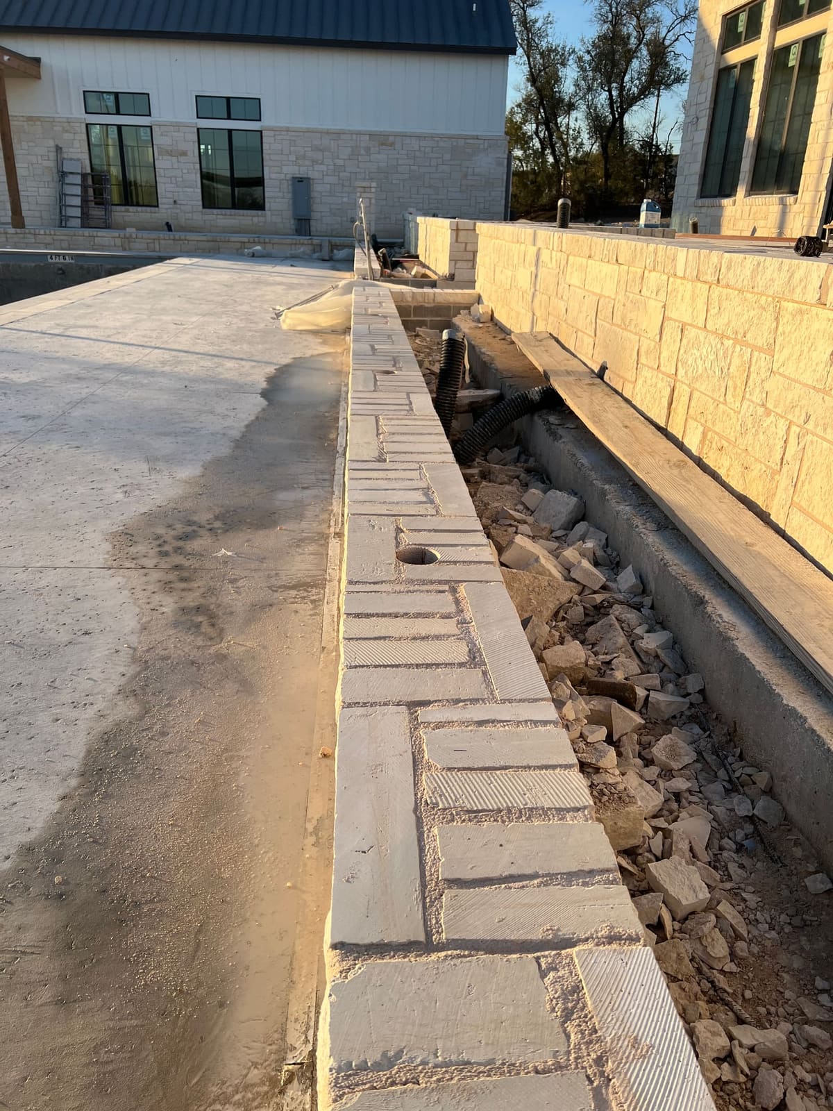 Core hole drilled into a limestone retaining wall cap