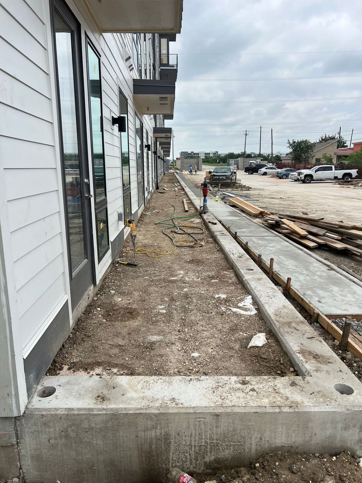 A poured concrete retaining wall foundation prepped for railing posts